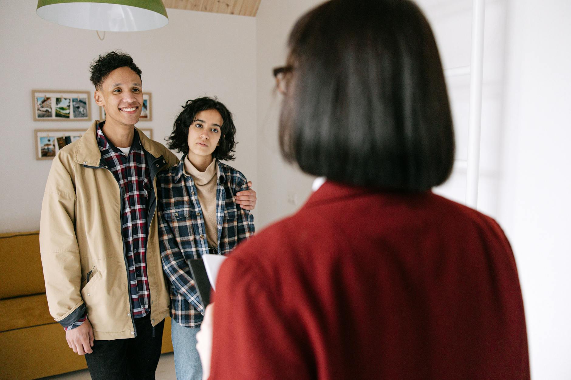 couple standing in front of real estate agent